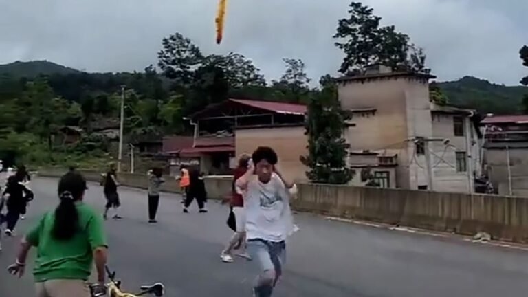 Suspected Chinese missile debris is seen falling over the village